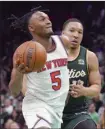  ?? AP photo ?? Immanuel Quickley of the Knicks drives against the Celtics’ Grant Williams in the second overtime Sunday.