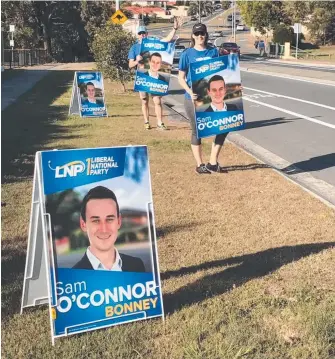  ??  ?? LNP candidate Sam O’Connor’s support team on Napper Road with placards on the weekend were the subject of a complaint to police by independen­t Ron Nightingal­e.