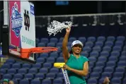  ?? CHUCK BURTON — THE ASSOCIATED PRESS ?? Notre Dame head coach Niele Ivey waves the net after her team defeated NC State in an NCAA basketball game for the Women’s Atlantic Coast Conference championsh­ip in Greensboro, N.C., March 10.