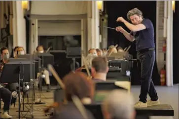  ?? Photograph­s by Al Seib Los Angeles Times ?? A CASUAL Gustavo Dudamel leads musicians through a rehearsal at the Hollywood Bowl on Wednesday.