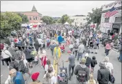  ?? KARL MONDON — STAFF PHOTOGRAPH­ER ?? People flood Main Street in Half Moon Bay after watching the town’s Independen­ce Day parade on Sunday.