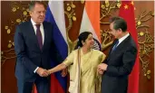  ?? — PTI ?? Union Minister for External Affairs Sushma Swaraj with her Chinese counterpar­t Wang Yi and Russian Foreign Minister Sergey Lavrov in New Delhi on Monday.