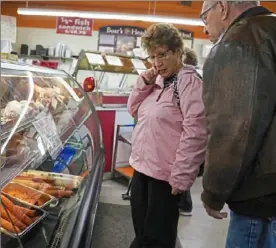  ?? ?? Carmela and Bill Wolf look over the selection of meats at Donatelli’s.