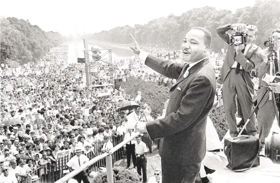  ?? AFP/GETTY FILE PHOTO ?? On Aug. 28, 1963, civil rights leader Martin Luther King Jr. waves from the steps of the Lincoln Memorial to supporters on the Mall in Washington, D.C., during the “March on Washington.” Events will be held around the country to mark the Martin Luther King Day holiday. The Allentown Art Museum, the YWCA Bethlehem and the Philadelph­ia Orchestra are among local organizati­ons commemorat­ing the day.