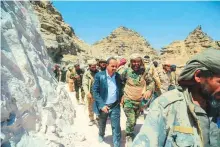  ?? Courtesy: Saba ?? Yemen Informatio­n Minister Muammar Al Aryani (centre) inspects government forces in the district of Baqim in the northern province of Saada, a stronghold of Al Houthis.