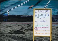  ??  ?? A message board posted on the pool deck of the Walter V. Graham Aquatic Center informs swimmers of the COVID-19 guidelines that are in place during all water fitness classes.