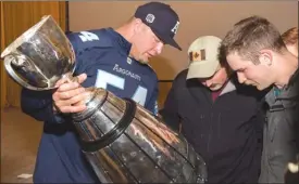  ?? The Canadian Press ?? Toronto Argonaut Chris Van Zeyl shows the Grey Cup to Canadian Forces members deployed on Operation UNIFIER during Team Canada’s spring visit to Starychi, Ukraine, on Sunday.