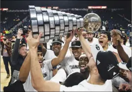  ?? CP PHoTo ?? Members of the Carleton Ravens men’s basketball team raise the W.P McGee Trophy following their win over the Ryerson Rams in the national championsh­ip game in Halifax on Sunday.