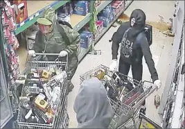  ?? SuBmitted ?? Colchester RCMP are seeking public assistance in identifyin­g four suspects who stole liquor from the Co-Op in Upper Stewiacke. The suspects filled shopping carts full of booze before unloading them into the back of a Chevrolet truck.