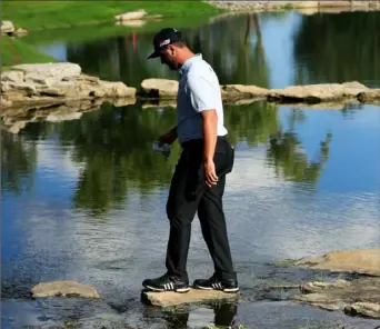  ?? Cliff Hawkins/Getty Images ?? Jon Rahm navigates the water between the 16th green and 17th tee Saturday in the third round of The Northern Trust at Liberty National Golf Club in Jersey City, N.J.