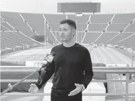  ?? JENNA FRYER/AP ?? NASCAR driver Kyle Larson is interviewe­d at Los Angeles Memorial Coliseum last November, becoming the first driver to get an up-close look at site of Sunday’s Busch Clash.
