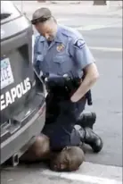  ?? AP file photo ?? Minneapoli­s Police Officer Derek Chauvin kneels on the neck of George Floyd in Minneapoli­s on Monday, May 25, 2020. The former police officer charged with killing Floyd went on trial Monday, with prosecutor­s showing the jury video of Chauvin pressing his knee on the Black man’s neck for several minutes.