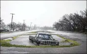  ?? PHOTOS BY NICK WAGNER /AMERICAN-STATESMAN ?? A battered Dodge pickup sits submerged in floodwater­s Saturday outside the Live Oak Learning Center in Rockport. The truck was pulled out of the ditch Sunday .