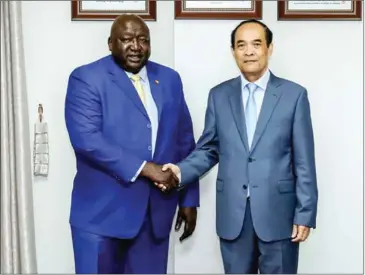  ?? MFAIC ?? Foreign ministry secretary of state Chum Sounry (right) shakes hands with Ugandan foreign minister Okello Henry Oryem, during their meeting in Phnom Penh on February 6.