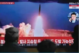  ?? —AFP ?? SEOUL: People watch a television showing a news broadcast with file footage of a North Korean missile test, at a railway station in Seoul on March 19, 2023.