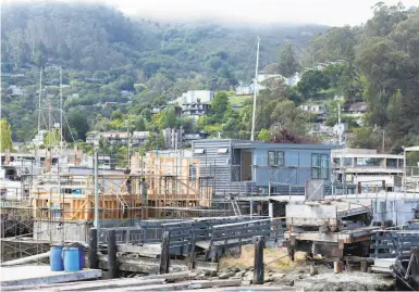  ?? Photos by McArdle Hankin / The Chronicle ?? Floating homes under constructi­on in Sausalito, where officials are weighing new housing proposals.