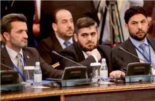  ?? AP ?? Mohammed Alloush, centre, head of the Syrian opposition delegation, and other members attend talks on Syrian peace in Astana, Kazakhstan, on Monday. —