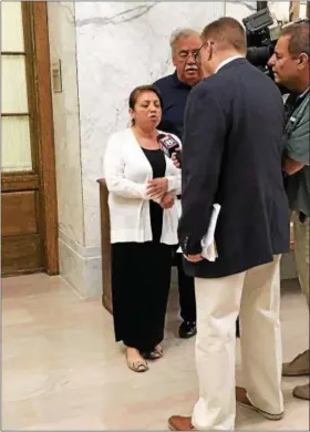  ?? TRACEY READ — THE NEWS-HERALD ?? Mentor psychic Gina Miller refuses to answer TV reporters’ questions April 27 before her sentencing hearing in Lake County Common Pleas Court. Miller received the maximum eight years in prison for stealing $1.4 million from 12 clients.