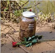  ?? PHOTO CONTRIBUTE­D BY THE REV. PATRICIA TEMPLETON ?? Members from the Fulton County Remembranc­e Coalition collected soil from the riverbank near the area where the body of Mack Henry Brown was found in 1936.