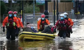  ??  ?? Rescuers help people affected by flooding in Northwich, Cheshire. Photograph: Chris Furlong/Getty Images