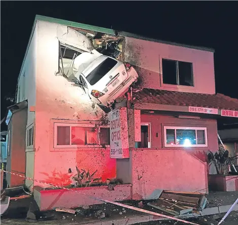  ??  ?? A CAR was left embedded in the first floor of a dental practice in Santa Ana, California, after it struck a lane divider and became airborne. The Orange County Fire Authority and Los Angeles County Urban Search and Rescue said that the occupants of the...