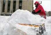  ?? ROBERT FRANKLIN / SOUTH BEND TRIBUNE ?? Roger Smedley, a South Bend employee, shovels a downtown sidewalk Friday as northern Indiana is hit by a winter storm. Eight inches was reported as of early Friday in northern Indiana.