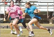  ?? Westside Eagle Observer/RANDY MOLL ?? Presley Ward (a sophomore) runs the ball while Gabi Johnson (a teacher and senior class sponsor) tries to catch up during Wednesday’s powderpuff football game in Gentry.