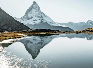  ??  ?? PREVIOUS PAGE: Skiing and snowboardi­ng station at Saas-FeeABOVE AND RIGHT: Matterhorn's reflection on the Riffel lake, Zermatt; and a freerider in Verbier