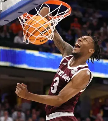  ?? Andy Lyons/Getty Images ?? Texas A&M’s Quenton Jackson dunks in the second half of the Aggies’ 67-62 upset of No. 4 Auburn in the quarterfin­als of the SEC tournament in Tampa, Fla.