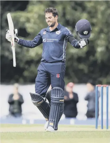  ??  ?? 0 Scotland’s Calum Macleod celebrates his century against Afghanista­n at The Grange yesterday.