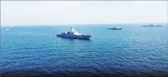  ?? ?? In this handout photo taken from video and released by Russian Defense Ministry Press Service on Saturday, March 18, 2023, warships are seen during Russia, China and Iran joint naval exercise in the Arabian Sea. Russia, China and Iran finished joint naval exercise in Arabian Sea, the Russian military reported Saturday. According to the Defense Ministry, the navy practiced joint tactical maneuverin­g, carried out artillery firing as well as releasing a captured ship with hostages and providing assistance to a ship in distress at sea. (AP)