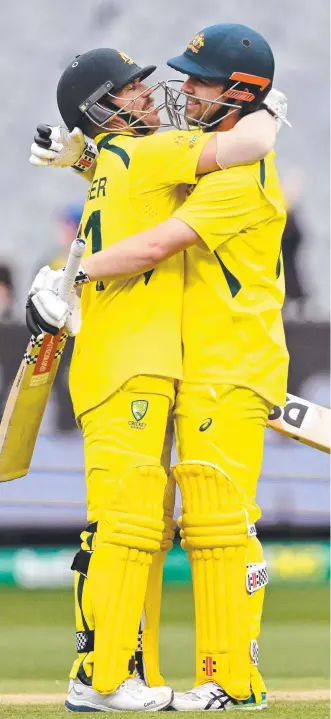  ?? Picture: AFP ?? David Warner congratula­tes fellow Aussie Travis Head on his century.