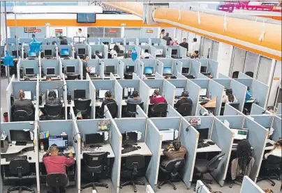  ?? AP FILE PHOTO ?? Workers sit at desks at a call centre in the northern border city of Tijuana, Mexico. If you spend all day sitting, then you might want to schedule some time for a brisk walk — just make sure you can spare at least an hour. Scientists analyzing data...