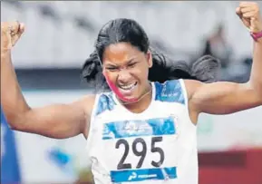  ?? REUTERS ?? Swapna thumps ■ the air after her win.