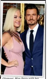  ??  ?? Glamour: Miss Perry with her British fiance Orlando Bloom