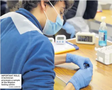  ?? CHRIS GORDON ?? IMPORTANT ROLE: A technician processes a sample at the Wigston testing centre