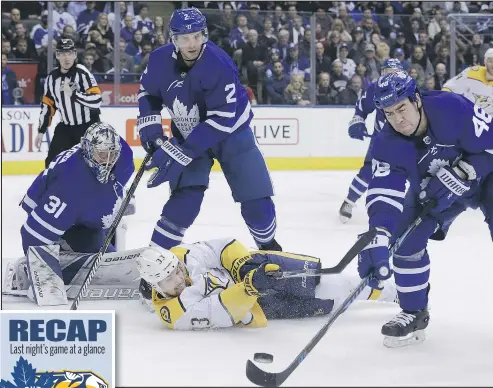  ?? STAN BEHAL/TORONTO SUN ?? Leafs goalie Frederik Andersen watches as defenceman Roman Polak fights to control the puck during the second period against the Nashville Predators last night at the ACC. Andersen was back in net after having to leave Monday’s game against the Anaheim...