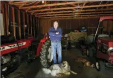  ?? BRYNN ANDERSON — THE ASSOCIATED PRESS ?? Rick Bragg, 58, stands in his mother’s garage with the family dog in Jacksonvil­le, Ala.