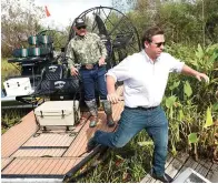  ?? (AP photo/wilfredo Lee, File) ?? Then-republican candidate for Florida Gov. Ron Desantis, gets off an airboat on Sept. 12, 2018, with Gladesman and former Florida Fish and Wildlife Conservati­on commission­er Ron Bergeron after a tour of the Florida Everglades in Fort Lauderdale, Fla.