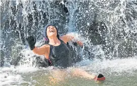  ?? ?? Plucky Gayle enjoys a cold shower under the waterfall.