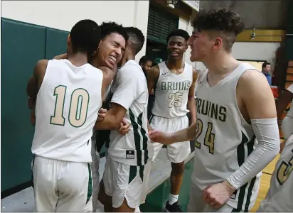  ?? CHRIS RILEY — TIMES-HERALD ?? Jalen Scott celebrates with the St. Patrick-St. Vincent’s boys basketball team after hitting the winning shot in the final seconds of Tuesday’s 58-57NorCal playoff victory over San Ramon Valley.