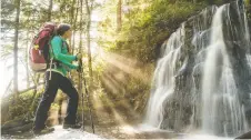  ?? SCOTT MUNN ?? A hiker takes in the picturesqu­e waterfall at Bonilla Creek on the West Coast Trail. The hike is challengin­g and diverse.