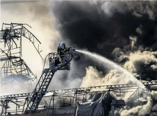  ?? PHOTOGRAPH: EMIL HELMS/EPA ?? Firefighte­rs battle the blaze at the Børsen in Copenhagen, Denmark, which was being renovated