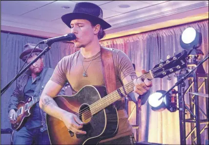  ?? FRAM DINSHAW/ TRURO NEWS ?? Singer Cameron Nickerson expresses himself through traditiona­l roots music, as seen here at the Holiday Inn Truro during his performanc­e. Originally part of a band called The Rockabilly­s, Nickerson went solo and released his debut album Detours in January.