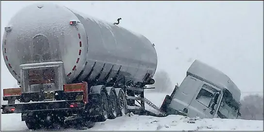  ??  ?? Descent into chaos: A fuel tanker jackknifed off the A9 at Drumochter in the appalling conditions, causing severe traffic disruption