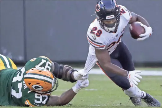  ?? WM. GLASHEEN / USA TODAY NETWORK ?? Green Bay’s Kenny Clark brings down Chicago running back Tarik Cohen on Sunday.