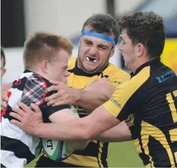  ?? NO F37 Lochaber Mull rugby 02. Photos: iain Ferguson, alba.photos ?? Daniel Thomas and Calum Boyd stop Mull’s Henry Shaw in his tracks.