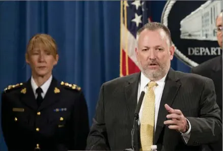  ?? ANDREW HARNIK, THE ASSOCIATED PRESS ?? Drug Enforcemen­t Administra­tion Acting Administra­tor Robert Patterson, centre, accompanie­d by Royal Canadian Mounted Police Assistant Commission­er Joanne Grace Crampton, left, announces indictment­s in Washington on Tuesday.