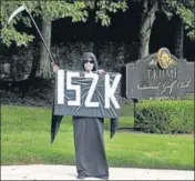  ?? REUTERS ?? A protester in a Grim Reaper costume holds up a sign showing ‘152K’ to represent the number of Covid-19 deaths in the US, outside the Trump National Golf Club in Washington, DC.