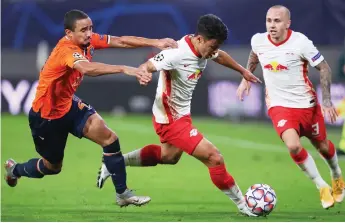  ?? — AFP photo ?? Istanbul Basaksehir’s defender Rafael (le ) and Leipzig’s forward Hwang Hee-chan vie for the ball next to defender Angelino during the UEFA Champions League Group H match in Leipzig, eastern Germany in this Oct 20 file photo.